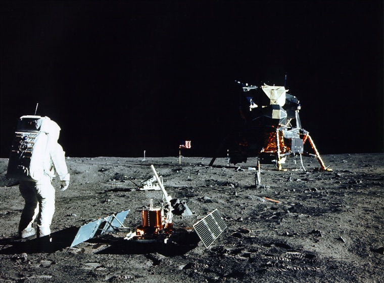 Astronaut Edwin E. Aldrin Jr., Lunar Module Pilot, stands near a scientific experiment on the lunar surface.