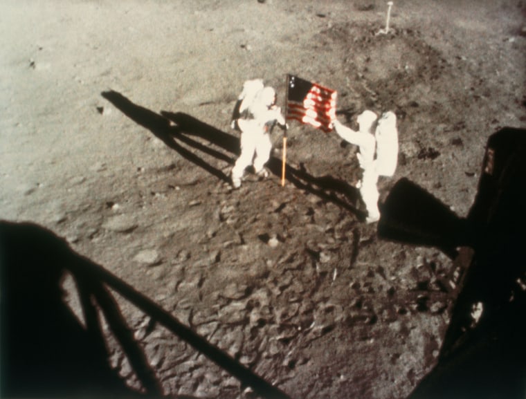 Astronauts Armstrong and Aldrin unfurling the US flag on the Moon, 1969.