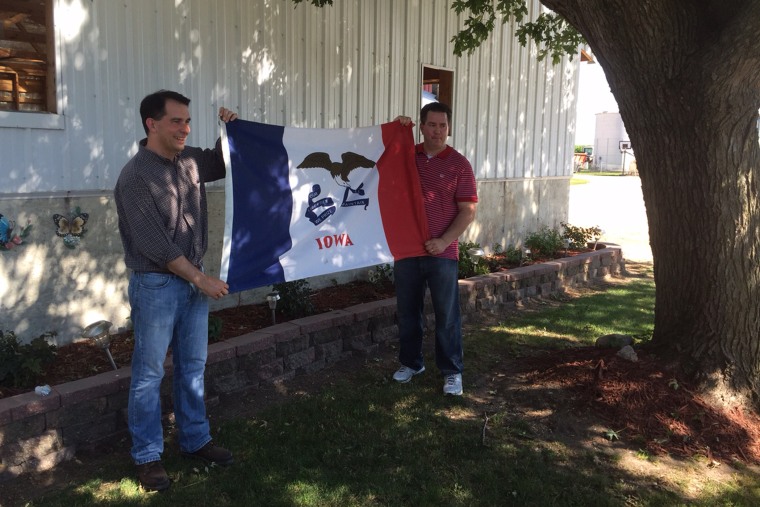 Scott Walker poses with an Iowa state flag in Plainfield, Iowa, where he spent part of his childhood on Jul. 19, 2015 (Photo by Benjamin Sarlin).