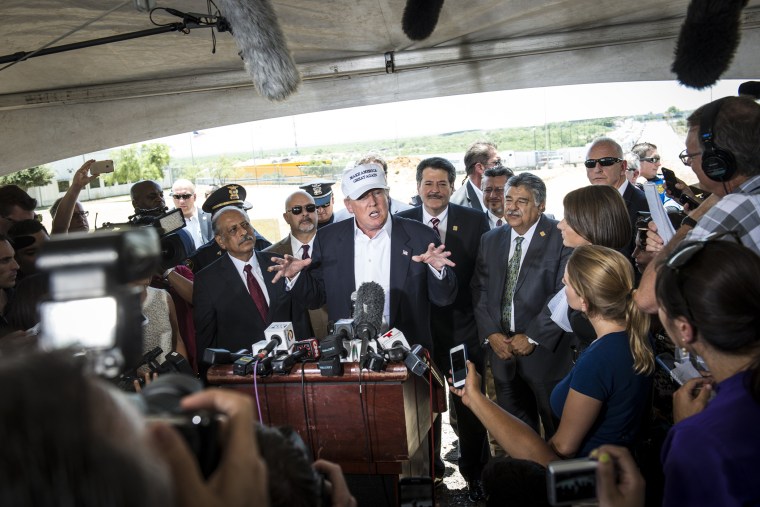 Republican Presidential candidate and business mogul Donald Trump talks to the media along the U.S. Mexico border during his trip to the border on July 23, 2015 in Laredo, Texas. (Photo by Matthew Busch/Getty)