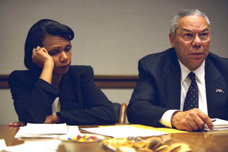 Secretary of State Colin Powell and National Security Advisor Condoleezza Rice meet with other staff members at the operations center. (Photo by David Bohrer/National Archives)