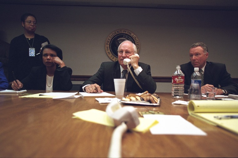 Cheney talks on the phone as Rice and Lewis \"Scooter\" Libby look on. (Photo by David Bohrer/National Archives)