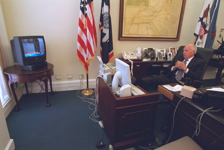 Smoke rises from the towers of the World Trade Center on a television in Vice President Dick Cheney's office as he watches coverage of the attacks on Sept. 11, 2001. (Photo by David Bohrer/National Archives)