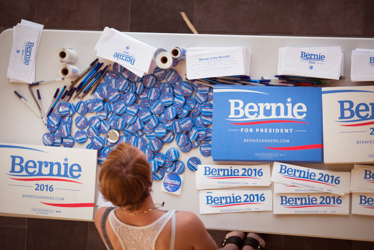A supporter of Democratic presidential candidate Senator Bernie Sanders (I-VT) looks over campaign materials at a town hall meeting hosted by the candidate at Valley High School on July 24, 2015 in West Des Moines, Iowa. (Photo by Scott Olson/Getty)