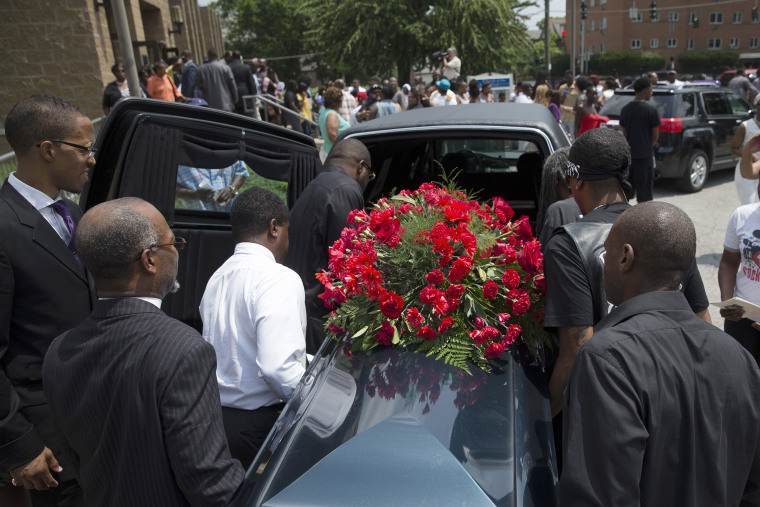 The casket of Samuel Dubose is transported to a hearse during his funeral at the Church of the Living God in the Avondale neighborhood of Cincinnati, July 28, 2015. (Photo by John Minchillo/AP)