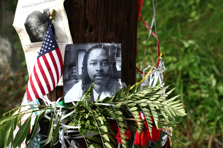 Photos of Samuel DuBose hang on a pole at a memorial, July 29, 2015 in Cincinnati, near where he was shot and killed by a University of Cincinnati police office. (Photo by Tom Uhlman/AP)