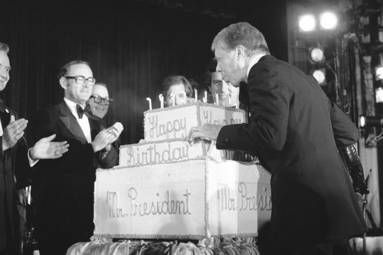 President Jimmy Carter blows out candles on a birthday cake presented him to adviser at a fundraiser for the Democratic National Committee in Washington, Sept. 28, 1978. (Photo by Barry Thumma/AP)