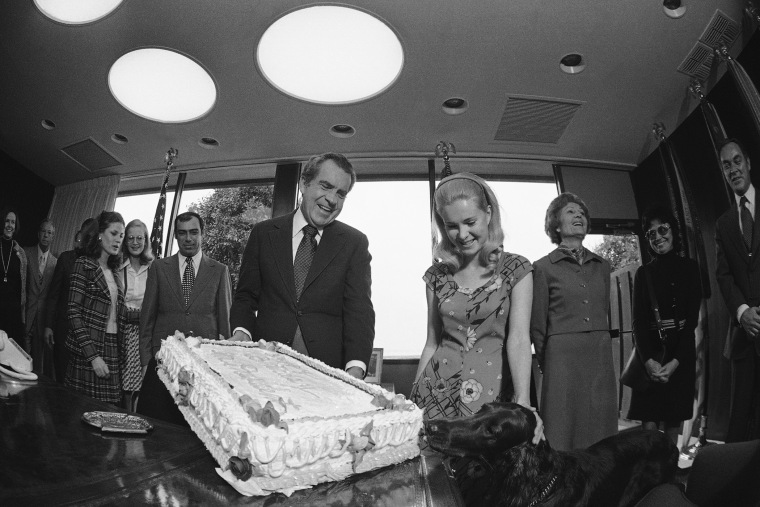 President Richard Nixon's dog King Timahoe takes a sample of the birthday cake presented to the president by the White House staff in a small party, Jan. 9, 1974 at the Western White House in San Clemente. (Photo by AP)