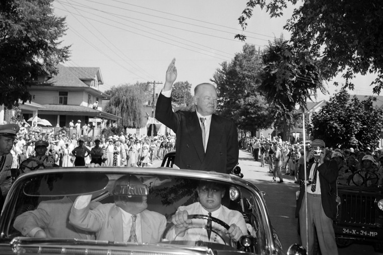 Former President Herbert Hoover waves to the crowd lining the streets of his birthplace at West Branch, Iowa, Aug. 10, 1954, as he arrives for day-long celebrations on his 80th birthday. (Photo by William P. Straeter/AP)