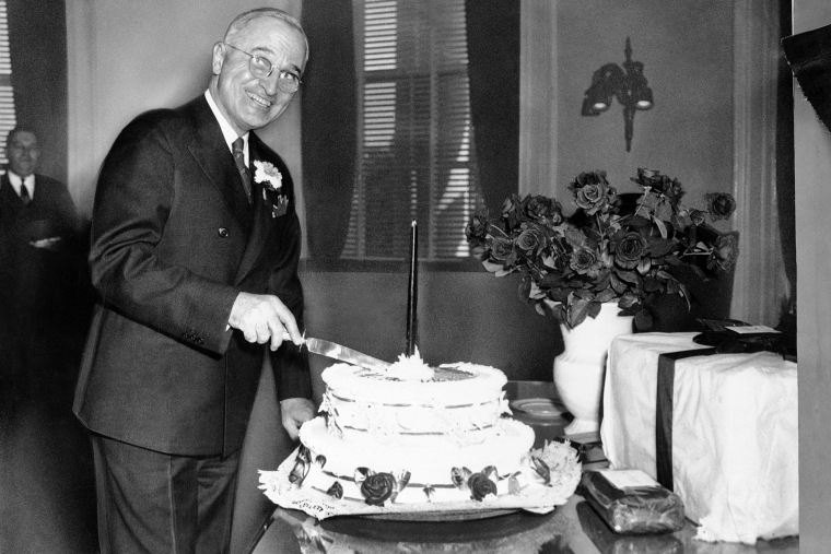 President Harry S. Truman cuts a cake on his 61st birthday anniversary in the White House, Washington, D.C., May 8, 1945. (Photo by AP)