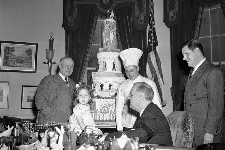 President Franklin D. Roosevelt coaxed a speech out of three-year-old Jill Myrup at the White House in Washington, Jan. 27, 1942. (Photo by George R. Skadding/AP)