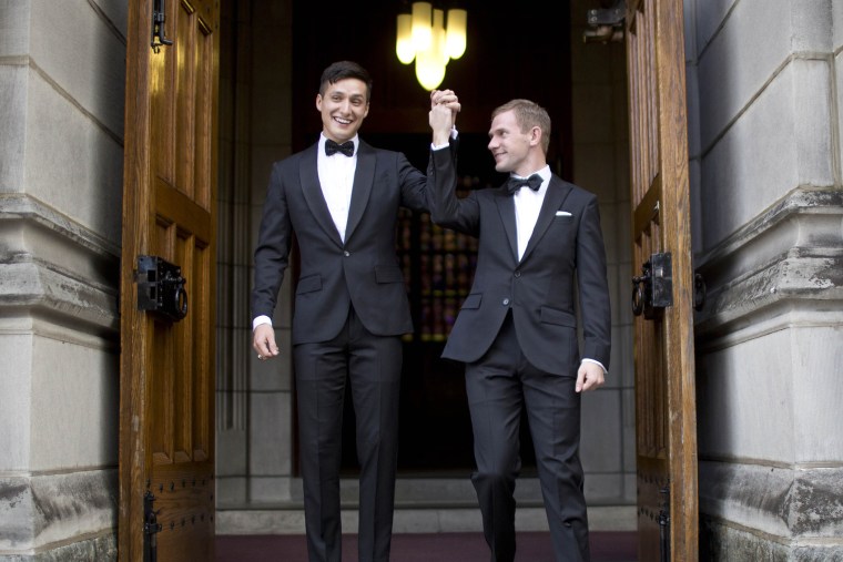 West Point graduate Larry Lennox-Choate, left, and Daniel Lennox-Choate, leave church following their wedding ceremony on Nov. 2, 2013, at the U.S. Military Academy's Cadet Chapel in West Point, N.Y. (Photo by Jill Knight/AP)