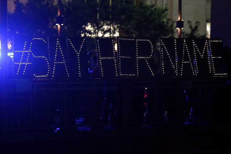 Protestors hold up a lighted sign reading \"#say her name\" during a vigil for Sandra Bland, July 28, 2015, in Chicago. (Photo by Christian K. Lee/AP)