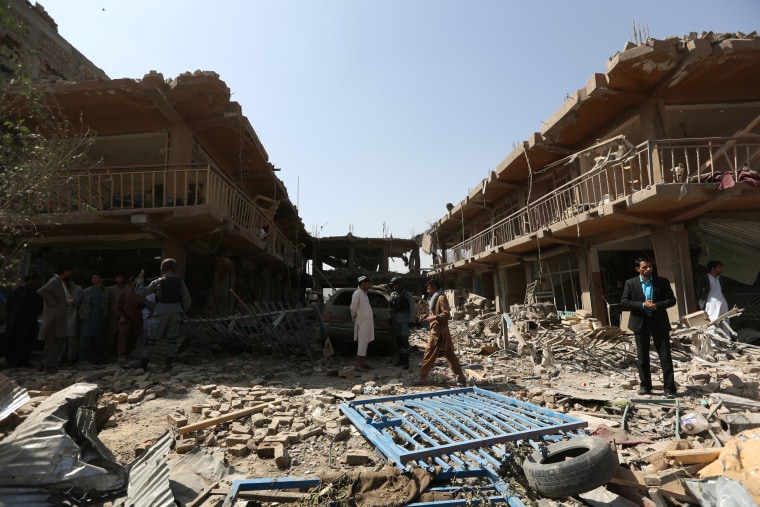 Afghans gather at the site of a car bomb attack in Kabul, Afghanistan, Friday, Aug. 7, 2015. (Photo by Rahmat Gul/AP)