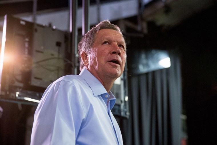 Republican presidential candidate, Ohio Gov. John Kasich, center, greets members of the media at Quicken Loans Arena in Cleveland, Aug. 6, 2015, before the first Republican presidential debate. (Photo by Andrew Harnik/AP)