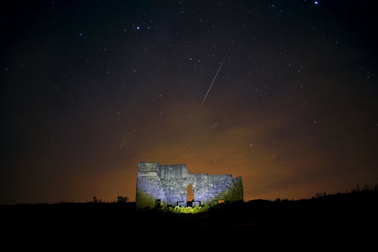 Meteors streak across the sky over a Roman theatre in the ruins of Acinipio, during the Perseid meteor shower near Ronda (Photo by Jon Nazca/Reuters)