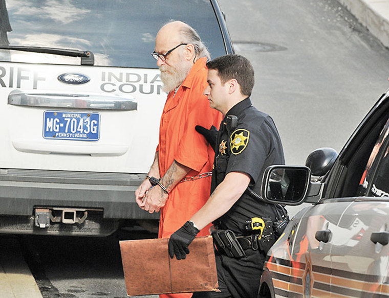 Lewis Fogle is escorted to the back door of the Indiana County Courthouse by Deputy Dave Angelo in Indiana, Pa., Aug. 13, 2015. (Photo by Tom Peel/The Indiana Gazette/AP)