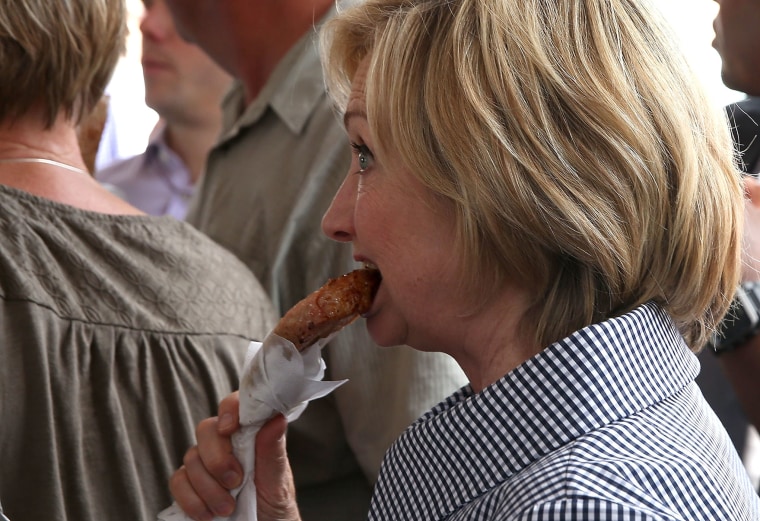 Democratic presidential hopeful and former Secretary of State Hillary Clinton eats a Pork Chop on a Stick as she tours the Iowa State Fair on Aug. 15, 2015 in Des Moines, Ia. (Photo by Justin Sullivan/Getty)