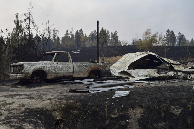 The charred remains of a pickup and barn are seen near Coyote Canyon on Aug. 16, 2015, near Fruitland, Wash.&nbsp;