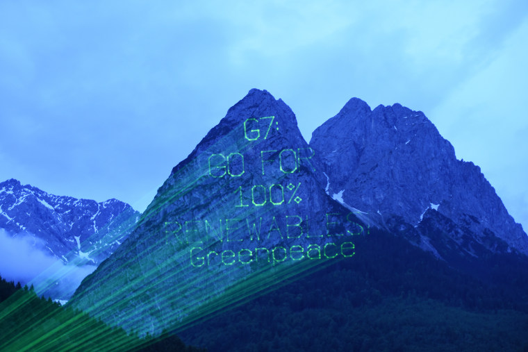 Greenpeace activists use laser beams to project \"G7: Go For 100% Renewables\" onto mountains near Elmau Castle, Germany, June 8th, 2015. (Photo by Felix Kaestle/EPA)