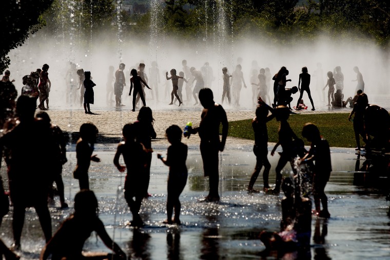 Children cool off as they play under a fountain next to the Manzanares river on July 21, 2015 in Madrid, Spain. (Photo by Pablo Blazquez Dominguez/Getty)