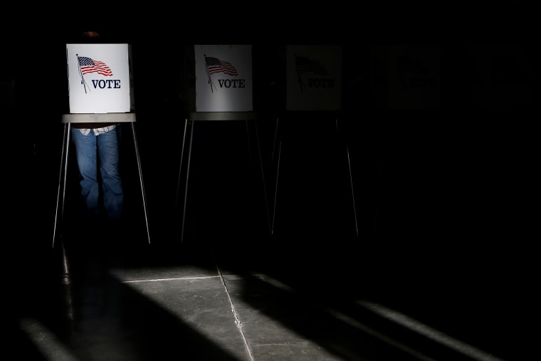 Voting booths are illuminated by sunlight as voters cast their ballots at a polling place on Nov. 6, 2012. (Photo by Jae C. Hong/AP)