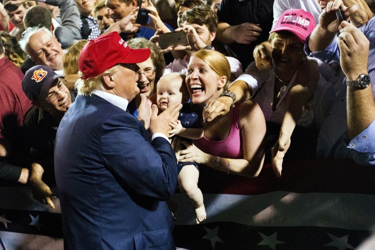 A woman with her baby shows excitement when the Republican presidential candidate Donald Trump greets them after he speaks at a campaign pep rally, Friday, Aug. 21, 2015, in Mobile, Ala. (Photo by Brynn Anderson/AP)