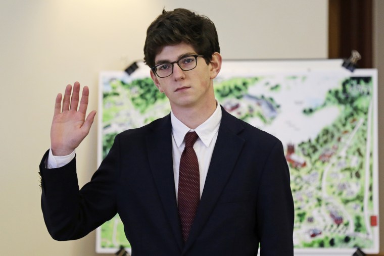 Former St. Paul's School student Owen Labrie raises his hand as he is sworn-in prior to testifying in his trial at Merrimack Superior Court in Concord, N.H., Wednesday, Aug. 26, 2015. (Photo by Charles Krupa/AP)
