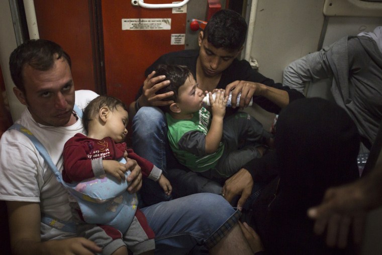 In this photo taken late, Aug. 27, 2015, migrants travel on an overnight train from the Macedonian town of Gevgelija, to the border with Serbia. (Photo by Santi Palacios/AP)