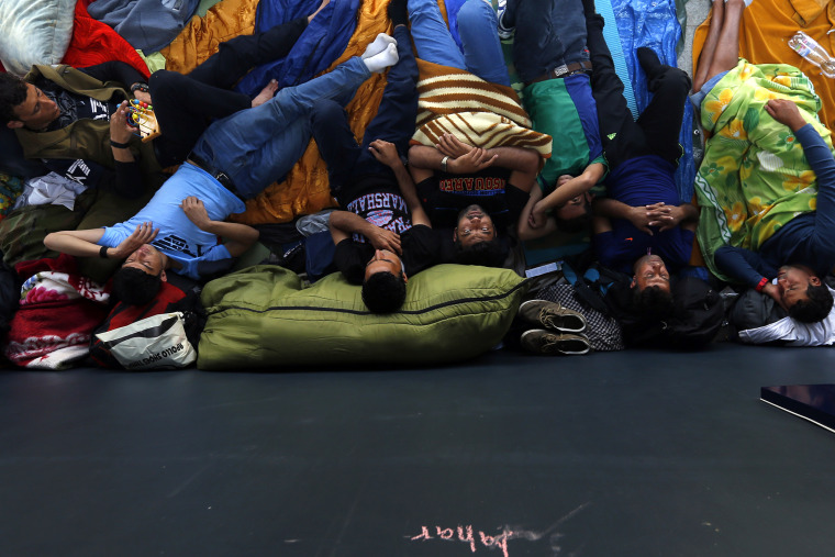 Asylum seekers sleep outside a train station in Budapest, Hungary, on Aug. 27, 2015. (Photo by Laszlo Balogh/Reuters)