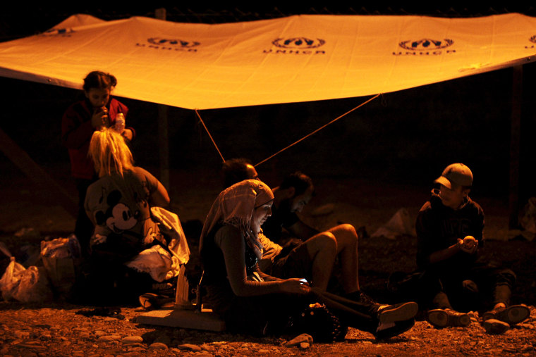 Migrants wait to get on the train from Macedonian south border near Gevgelija on Aug. 26, 2015 to Macedonian north border with Serbia on their way to Western Europe. (Photo by Ognen Teofilovski/Reuters)