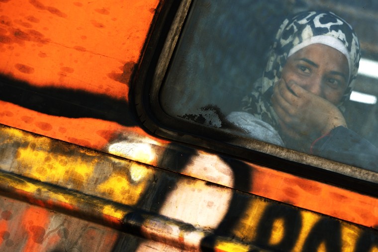 A migrant woman sits in the train at Gevgelija,The Former Yugoslav Republic of Macedonia, on Aug. 25, 2015. (Photo by Vassil Donev/EPA)