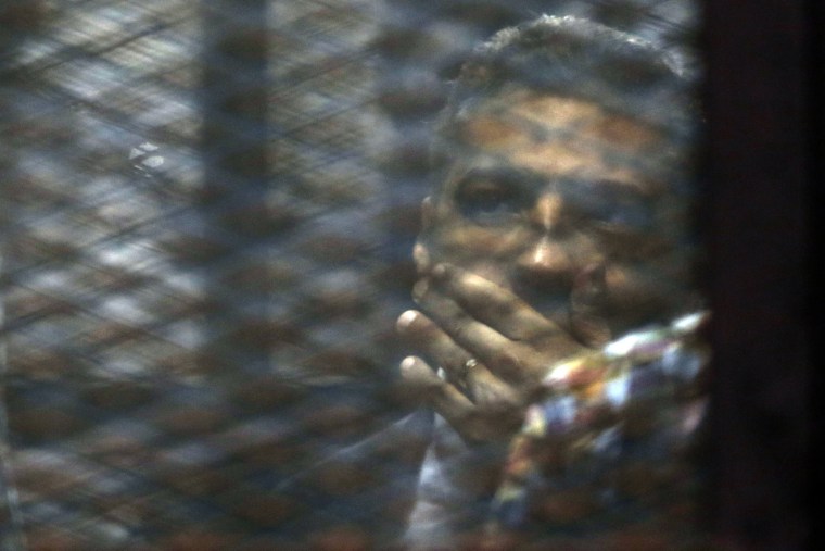 Canadian Al-Jazeera English journalist Mohammed Fahmy, listens to his verdict in a soundproof glass cage inside a makeshift courtroom in Tora prison in Cairo, Egypt, Aug. 29, 2015. (Photo by Amr Nabil/AP)