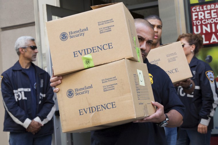 Law enforcement officers take evidence from the Manhattan offices of Rentboy.com in New York on Aug. 25, 2015. (Photo by Brendan McDermid/Reuters)