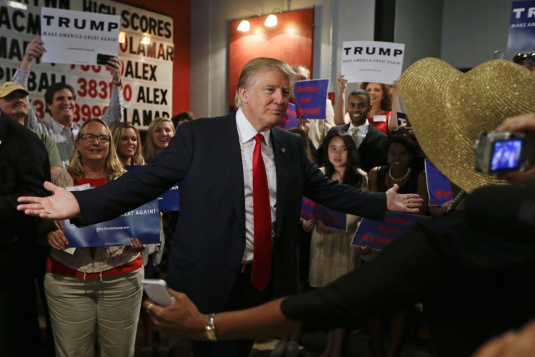 Republican presidential candidate Donald Trump reaches out to hug a supporter after he spoke at the National Federation of Republican Assemblies on Aug. 29, 2015, in Nashville, Tenn. (Photo by Mark Humphrey/AP)