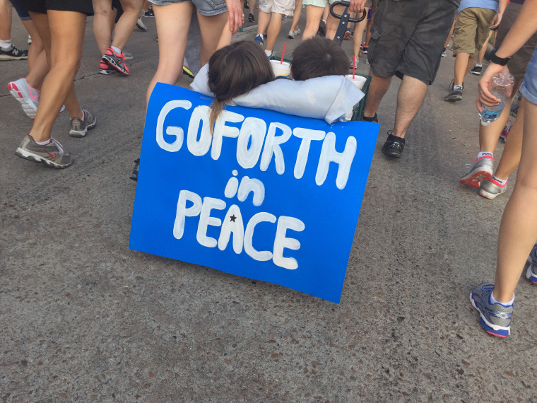 Children are pulled in a cart during a march on Aug. 30, 2015, commemorating sheriff's deputy Darren Goforth, who was shot dead at a northwest Houston gas station on Friday. (Photo by  James Novogrod/msnbc)