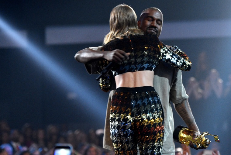 Recording artist Taylor Swift hugs recording artist Kanye West after presenting him with the Vanguard Award onstage during the 2015 MTV Video Music Awards at Microsoft Theater on Aug. 30, 2015 in Los Angeles, Calif. (Photo by Larry Busacca/MTV1415/Getty)