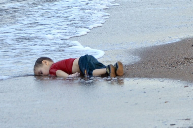 Washed up body of a refugee child who drowned during a failed attempt to sail to the Greek island of Kos, at the shore in the coastal town of Bodrum, Mugla city, Turkey, on Sept. 2, 2015. (Photo by Dogan News Agency/EPA)