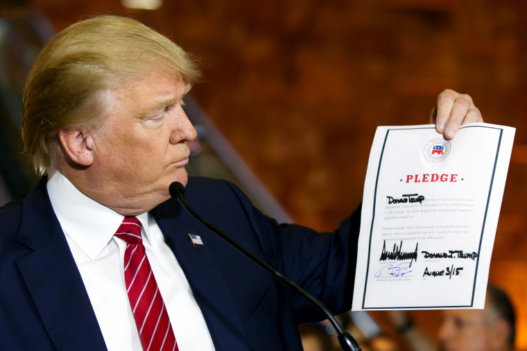 Republican presidential candidate Donald Trump looks at a signed pledge during a news conference in Trump Tower, Thursday, Sept. 3, 2015 in New York. (Photo Richard Drew/AP)