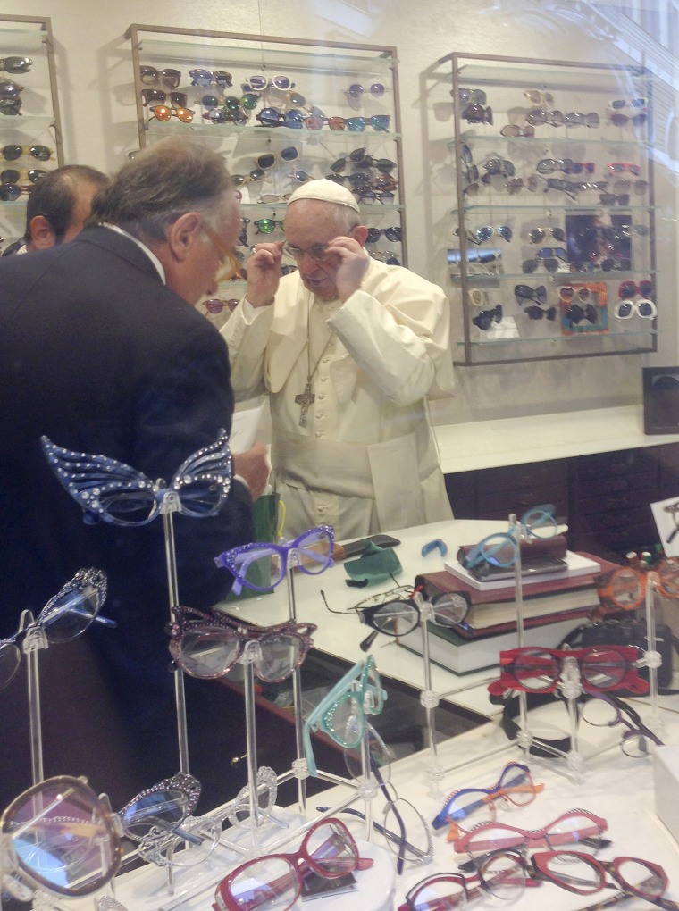 Pope Francis tries on a pair of glasses in an optical store in downtown Rome, Italy on Sept. 3, 2015. (Photo by Stringer Shanghai/Reuters)