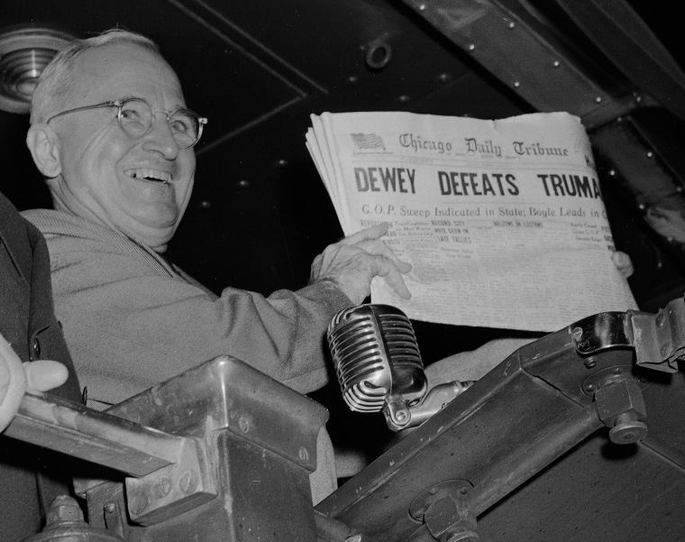 U.S. President Harry S. Truman holds up an Election Day edition of the Chicago Daily Tribune, which, based on early results, mistakenly announced \"Dewey Defeats Truman\" on Nov. 4, 1948. (Photo by Byron Rollins/AP)
