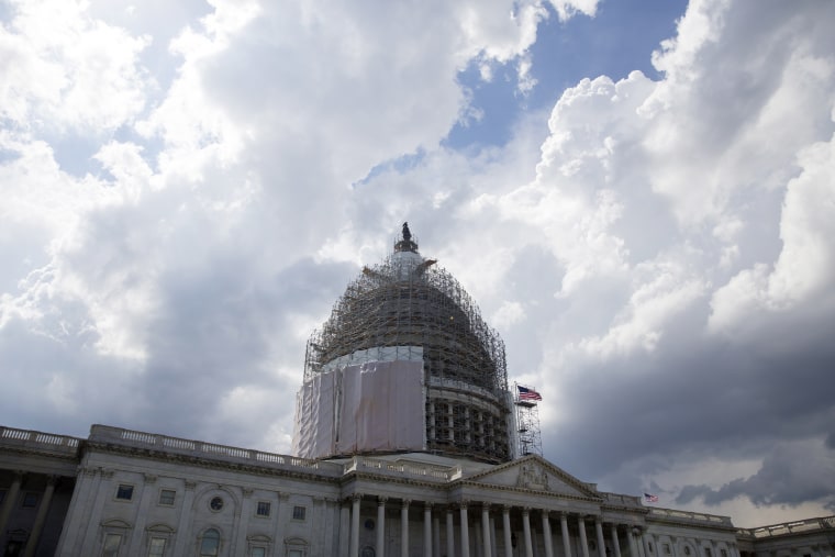 Storm clouds pass near the US Capitol Building, in Washington DC on June 1, 2015. (Photo by Michael Reynolds/EPA)