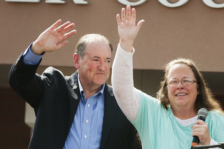 Republican presidential candidate Mike Huckabee (L) stands behind Rowan County Clerk of Courts Kim Davis (R) in front of the Carter County Detention Center on September 8, 2015 in Grayson, Kentucky. (Photo by Ty Wright/Getty)