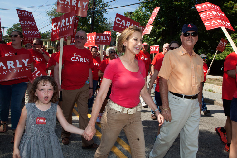 Republican presidential candidate Carly Fiorina, who has been rising in the polls, marches with her family in the Labor Day parade on Sep. 7, 2015 in Milford, N.H. (Photo by Kayana Szymczak/Getty)