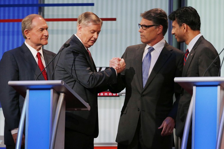 Former Virginia Governor Jim Gilmore (L) and former Texas Governor Rick Perry (2nd from R) will not be attending the upcoming lower-polling forum. Cleveland, Ohio, August 6, 2015. (Photo by Brian Snyder/Reuters)