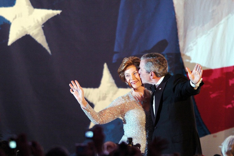 President George W. Bush kisses his wife, First Lady Laura Bush, during the Constitution Ball, the first in a series of events for the night following his second term inauguration on Jan. 20, 2005 in Washington, D.C. (Photo by Roberto Schmidt/AFP/Getty)