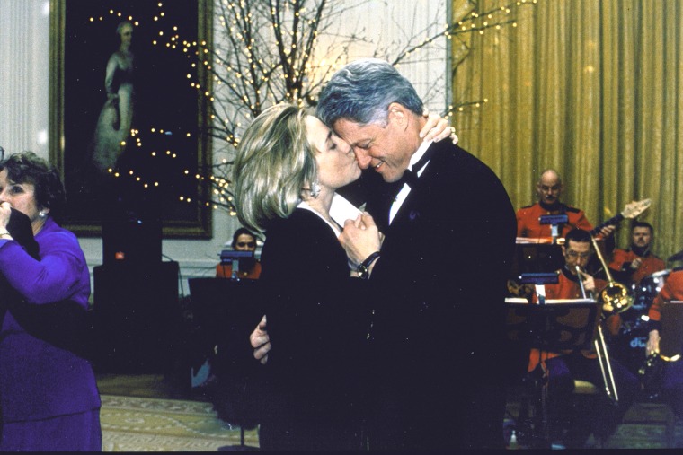 First Lady Hillary Clinton kisses her husband, American President Bill Clinton, while the pair dance at a White House dinner party, Washington D.C., 1997. (Photo by Barbara Kinney/White House/The LIFE Images Collection/Getty)