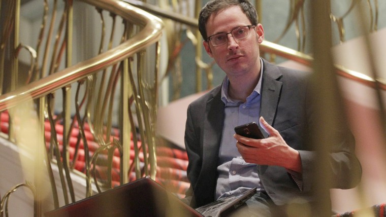 Nate Silver holds his phone as he sits on the stairs with his laptop computer at a hotel in Chicago on Nov. 9, 2012. (Photo by Nam Y. Huh/AP)