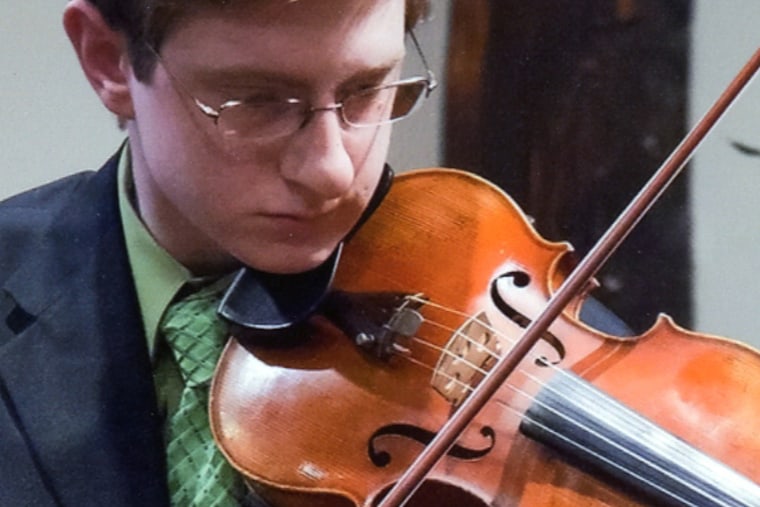 Tyler Clementi plays violin in a family photo.