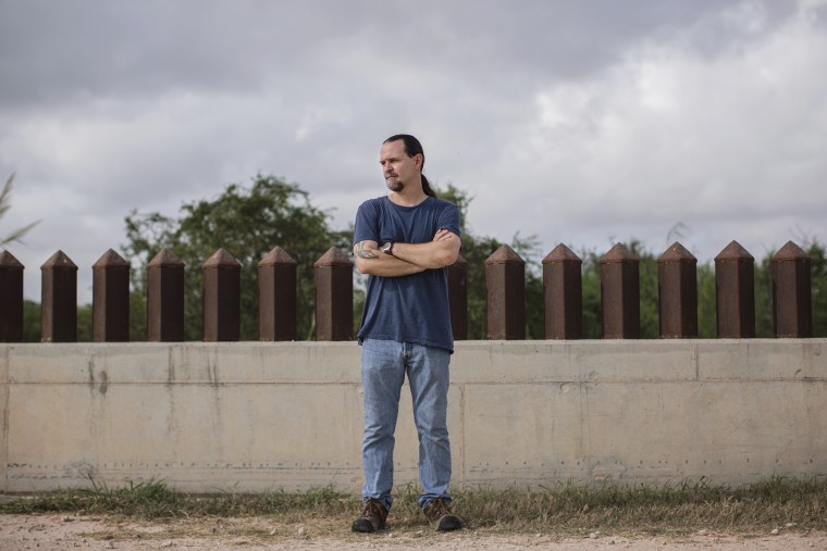 Scott Nicol, an artist and activist pitted against current immigration policy, stands beside the border fence which cuts through fish and wildlife land in Hidalgo, Texas. (Photo by Bryan Schutmaat for MSNBC)